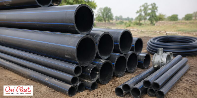 Stack of heavy-duty black HDPE agricultural pipes with blue stripes, ideal as the best borewell pipe for the region's irrigation.