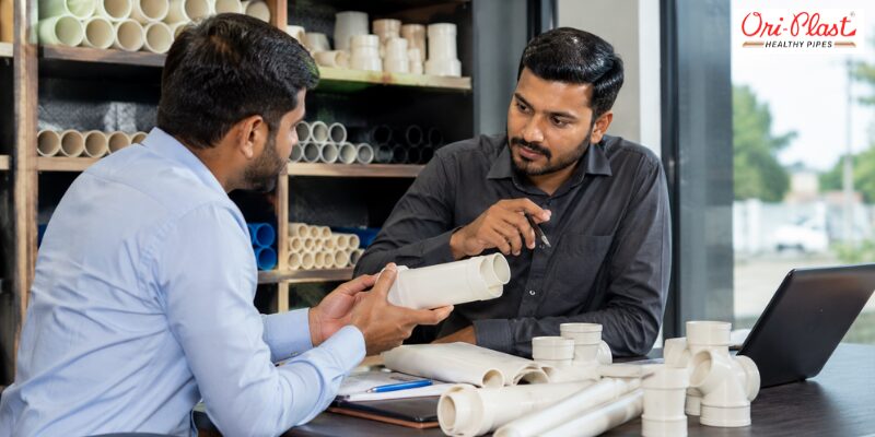 Customer and hardware dealer discussing pipe specifications and how to verify ISI mark details on PVC fittings.
